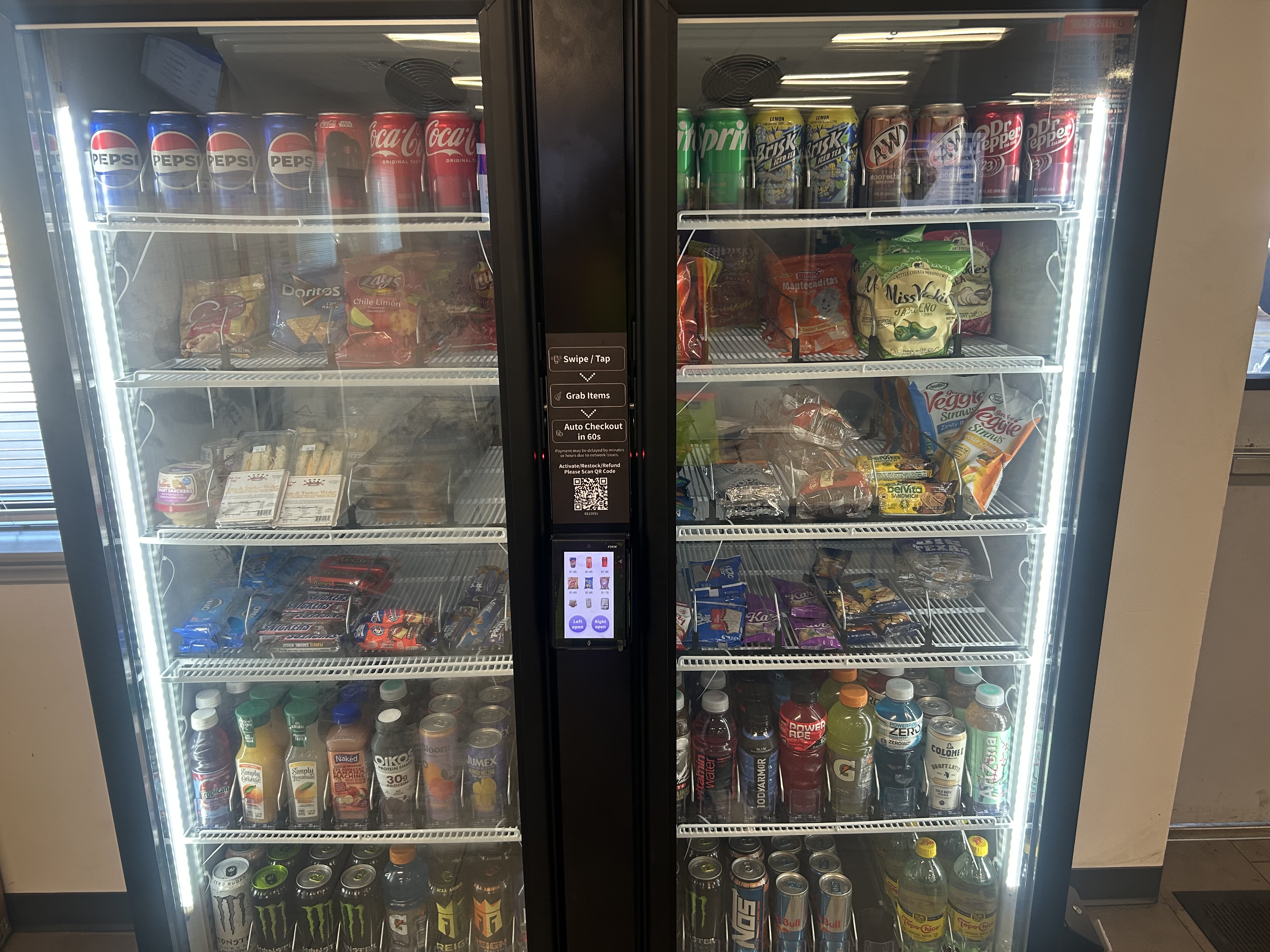 Double-door smart cooler fully stocked with drinks and snacks