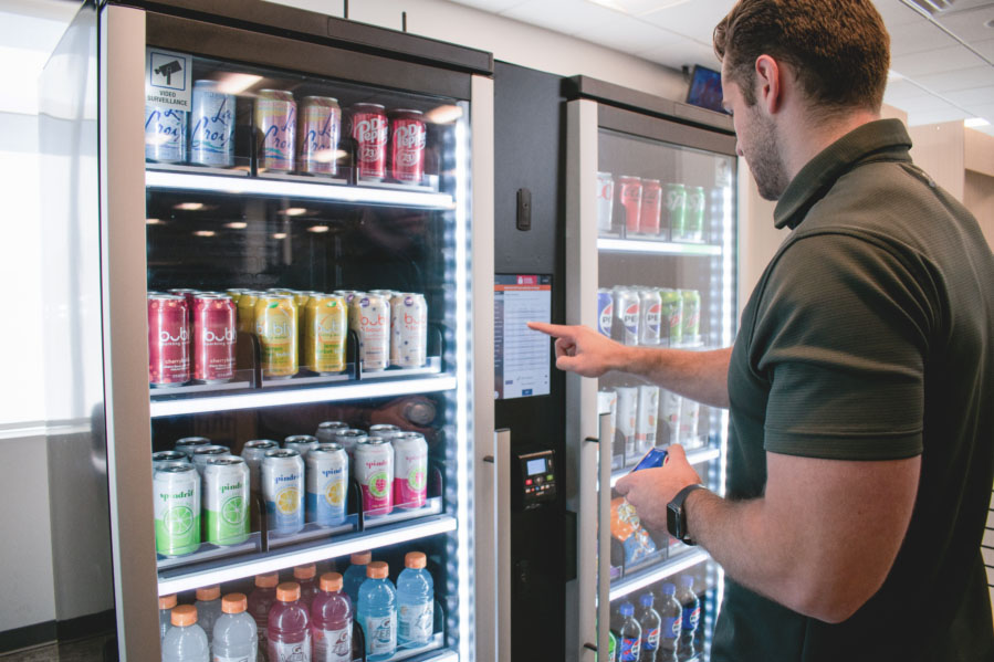 Employee using smart cooler touchscreen